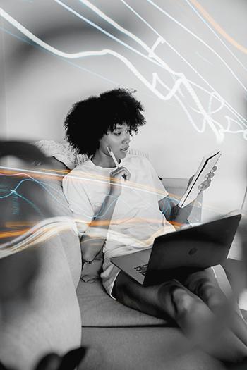 Professional working on a laptop from a sofa using Chromaport for flexible remote workstation access.