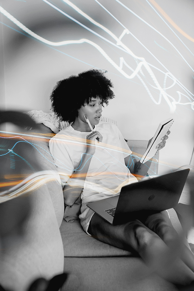 Professional working on a laptop from a sofa using Chromaport for flexible remote workstation access.